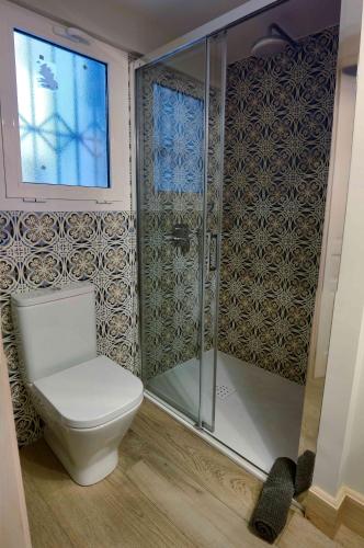 a bathroom with a toilet and a shower at Atico Estafeta in Pamplona
