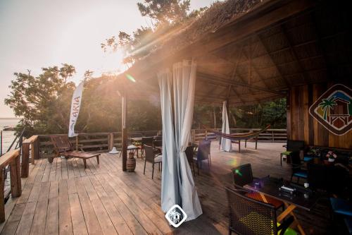 a deck with a tent and a table and chairs at Olaria River Hostel in Belém