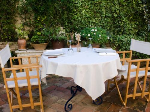 a table with a white table cloth on it at La Font D'Alcala in Alcalá de la Jovada