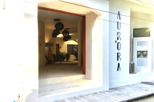 a white house with a mirror in the doorway at AURORA in Holbox Island