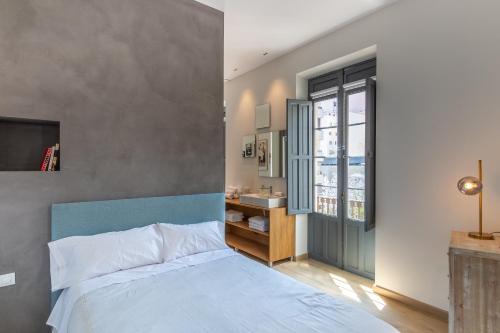 a bedroom with a bed and a sink in it at Balmis Plaza Apartments in Alicante