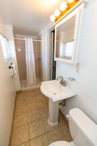 a white bathroom with a sink and a shower at Aztec Motel Wildwood Crest Beach in Wildwood Crest