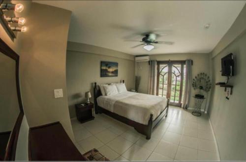 a bedroom with a bed and a ceiling fan at Punta Chame Villas in Punta Chame