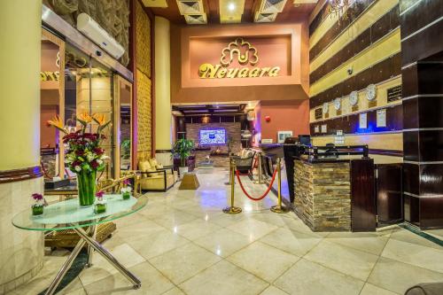 a lobby of a restaurant with tables and flowers at Al Muhaidb Al Malaz - Al Jamiah in Riyadh
