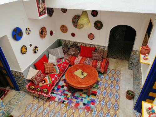 an overhead view of a living room with a table and couch at berber hostel in Essaouira