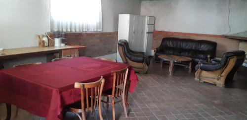 a dining room with a table and chairs and a refrigerator at Rocky Island in Kazbegi