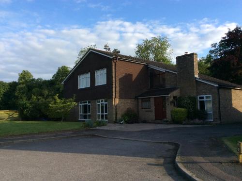 a brick house with a driveway in front of it at Cobblestones in Benington