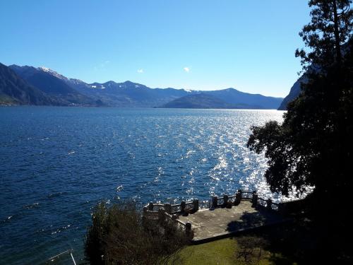 a large body of water with mountains in the background at IseoLakeRental - Casa del Pescatore in Riva di Solto