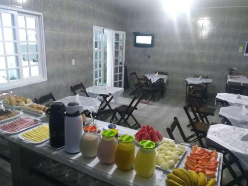 a table with a bunch of food on it at Dolce Mar Ubatuba Suites in Ubatuba