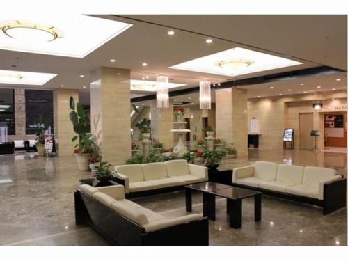 a lobby with couches and a table in a building at Hotel Nagoya Garden Palace in Nagoya