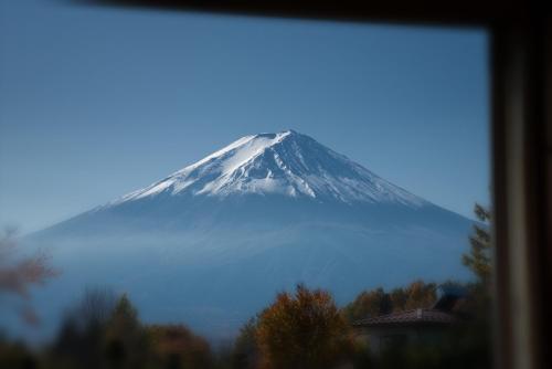 a snow capped mountain in the middle of a fog covered mountain at Fujimien in Fujikawaguchiko