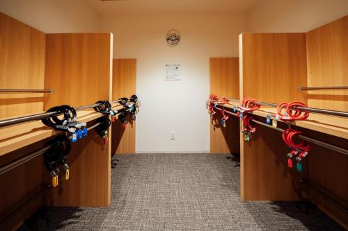 a hallway with a row ofabinets with wine racks at WeBase Hiroshima in Hiroshima