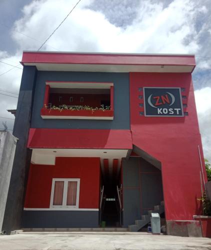 ein Fast-Food-Restaurant mit einem roten und blauen Gebäude in der Unterkunft RedDoorz near Terminal Mendolo Wonosobo in Wonosobo
