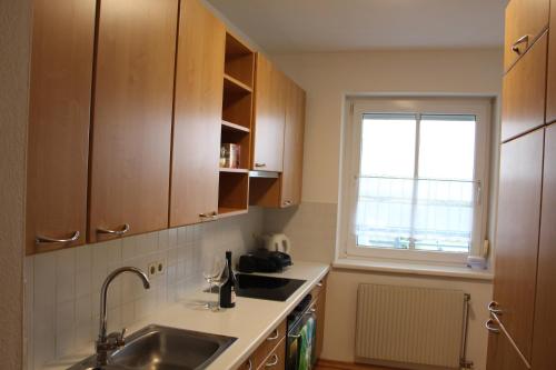 a small kitchen with a sink and a window at Ferienwohnung Dado in Eisenstadt