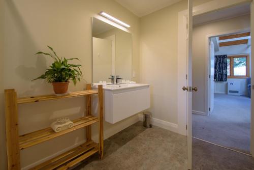 a bathroom with a sink and a mirror at Willowbrook Country Apartments in Arrowtown