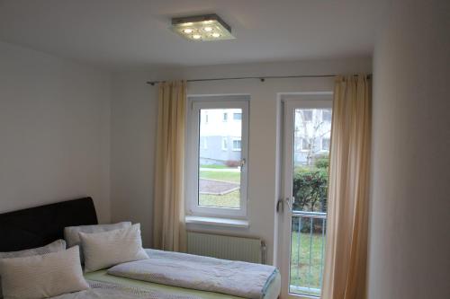 a room with a window and a couch in front at Ferienwohnung Dado in Eisenstadt