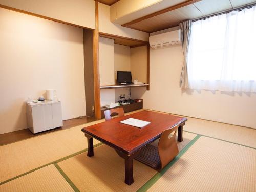 a room with a table and chairs and a window at Hotel Asyl Nara Annex in Nara