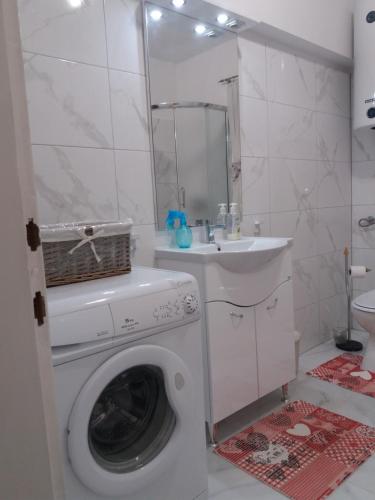 a bathroom with a washing machine and a sink at Villa Blue View in Sumpetar