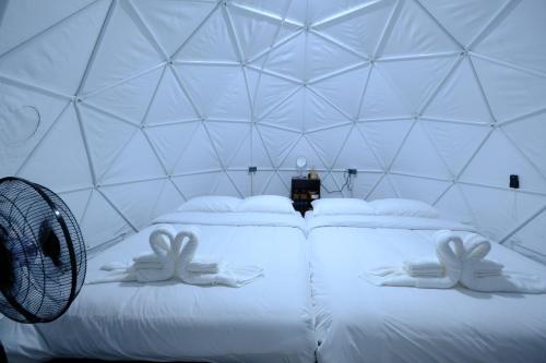 a room with two bunny pillows on a bed at Behind Khaokho in Phetchabun