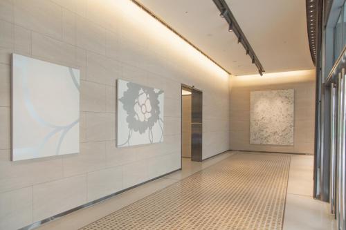 a hallway of a building with paintings on the wall at Eslite Hotel in Taipei