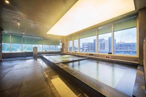 an empty bowling alley in a building with windows at Benikea Hotel Bizinn in Wonju