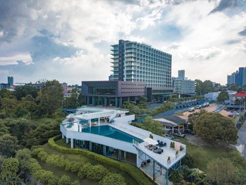 an aerial view of a building with a swimming pool at Tsix5 Phenomenal Hotel Pattaya in North Pattaya