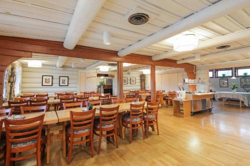 a large dining room with a long table and chairs at Dala Wärdshus in Rättvik