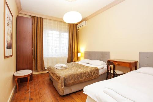 a hotel room with two beds and a window at guest house sultanahmet in Istanbul