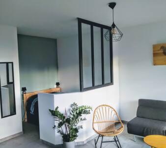 un salon avec un canapé et une chaise dans l'établissement Magnifique T1 Bis Vue mer Route des sanguinaires Ajaccio, à Ajaccio