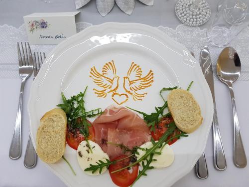 a plate of food with meat and vegetables on a table at Pension St. Maria in Staré Hory