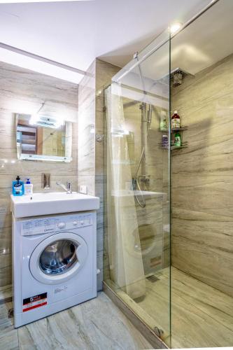 a washing machine in a bathroom with a shower at GVC New Gudauri 2 in Gudauri