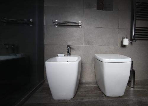 a bathroom with a toilet and a sink at Le Cupole Design in Palermo