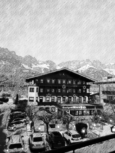 a large building with cars parked in front of it at Alte Post in Ellmau