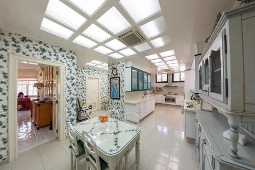 a kitchen with a table and a dining room at Villa Piera Maspalomas in Maspalomas