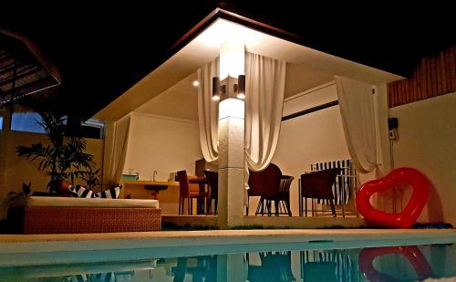 a house with a swimming pool and a dining room at Montecarlo Villas Panglao in Panglao