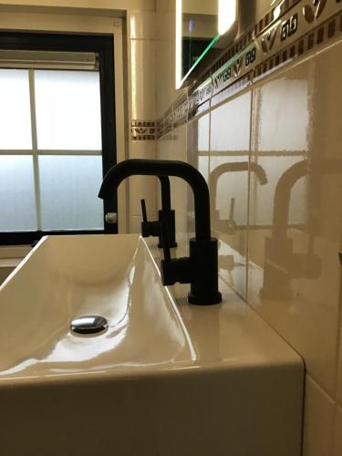 a sink with a faucet in a kitchen at RiemersHof in Ermelo