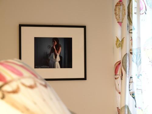 a picture of a woman on a wall at Apartments House Filipović in Makarska