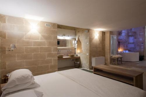 a large room with a bed and a kitchen at L'Hotel In Pietra in Matera