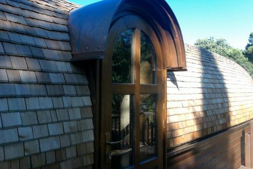 a building with a wooden door and an arched window at Les Gites De La Serre in Saint-Thibéry
