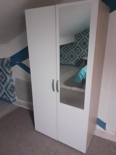 a white cabinet in a room with a bed at Un Spa au Canyon in Freyming