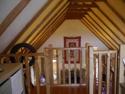 a staircase in a room with wooden beams at Wild Kerry Lodge in Glenbeigh