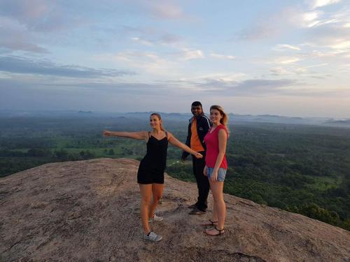 a group of people standing on top of a mountain at Sigiri Neo Homestay in Sigiriya