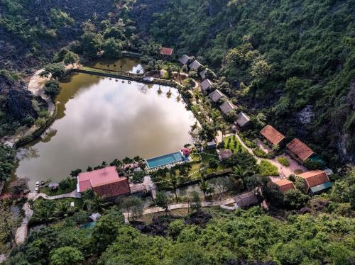 an aerial view of a house next to a lake at An's Eco Garden Resort in Ninh Binh