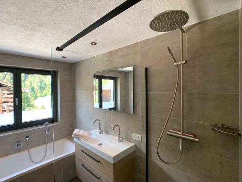 a bathroom with a shower and a sink at Chalet See Tirol - Ischgl/Kappl in See
