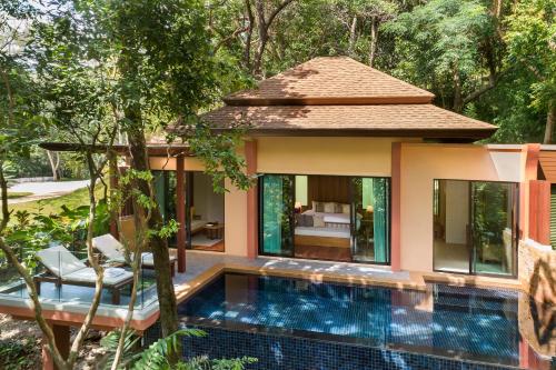 a villa with a swimming pool in a garden at Avani Ao Nang Cliff Krabi Resort in Ao Nang Beach