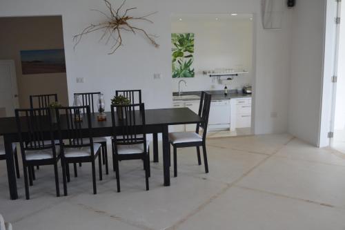 a black dining room table and chairs in a kitchen at Villa Noria in Las Terrenas
