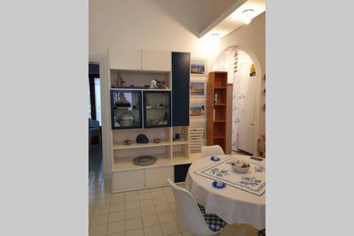 a dining room with a table and some shelves at Casa Alessia in Aci Castello