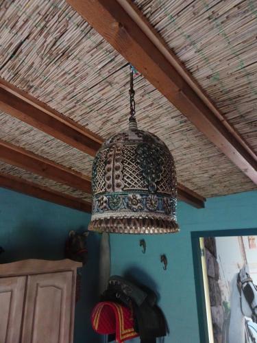 a chandelier hanging from a ceiling in a room at Casa Tranquila in Ooij