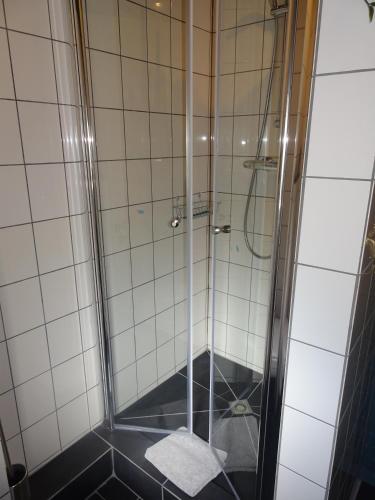 a shower with a glass door in a bathroom at Casa Tranquila in Ooij