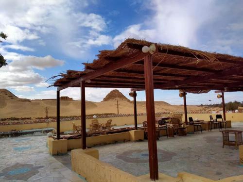 a pavilion with tables and chairs in the desert at Seror Guest House in Cairo